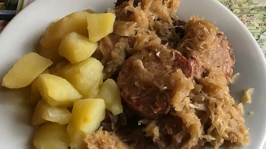 A plate of choucroute garnie with smoked sausage, pork and boiled potatoes
