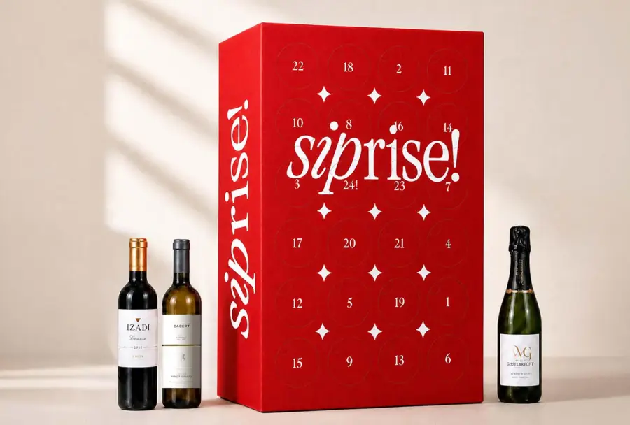 The red siprise! wine advent calendar box beside half-bottles of Izadi Rioja Crianza, Cabert Pinot Grigio and Willy Gisselbrecht Crémant d'Alsace
