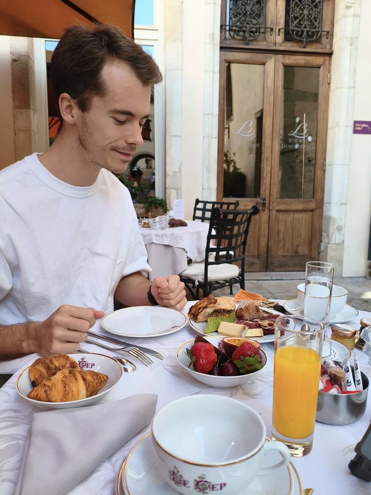 Breakfast at Le Cep in Beaune with pastries and a branded Le Cep coffee cup