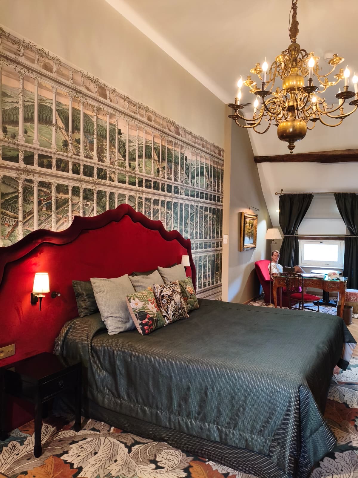 Guest room at Le Cep in Beaune with a red headboard and a Burgundy vineyard mural