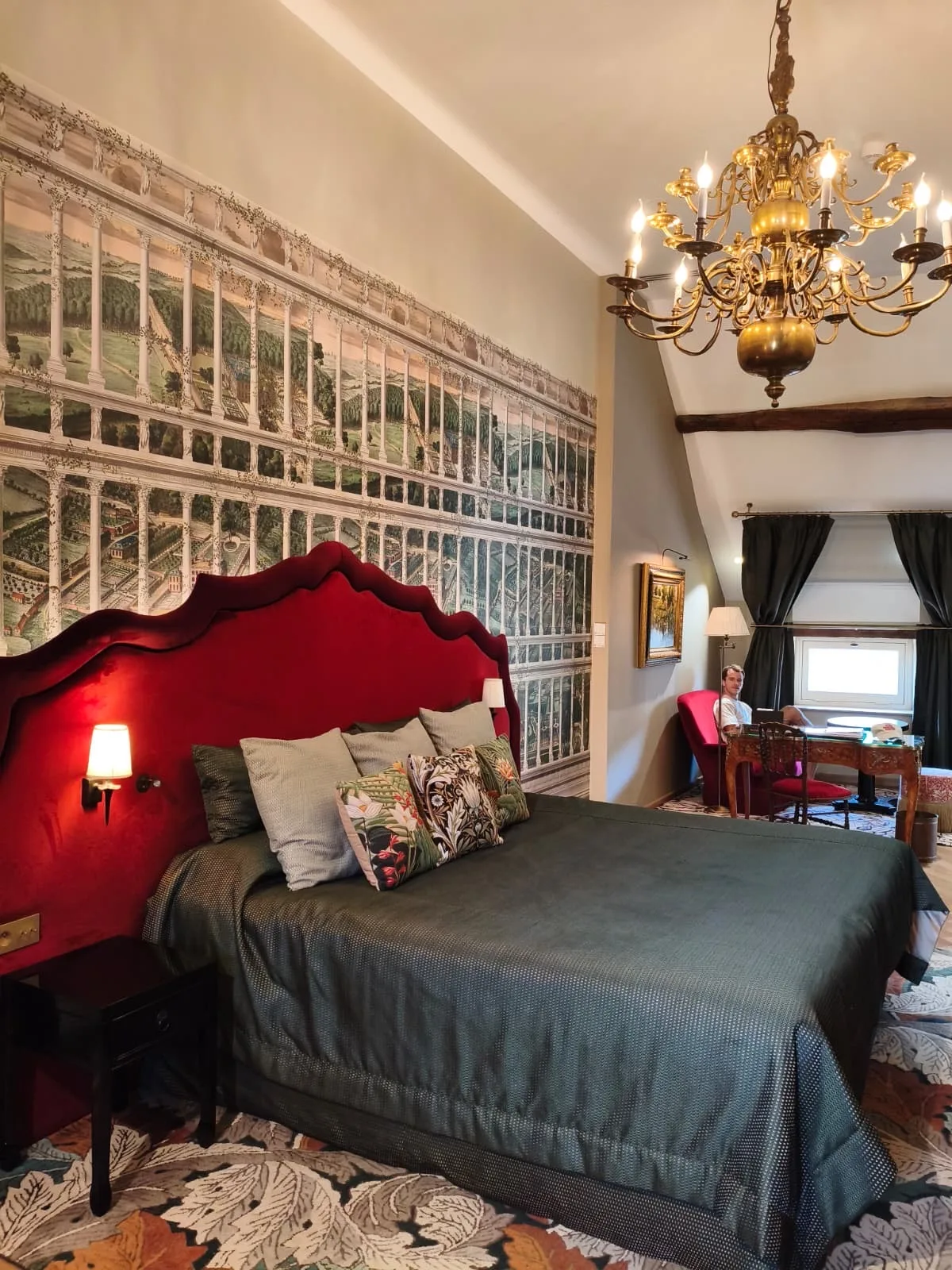 Guest room at Le Cep in Beaune with a red headboard and a Burgundy vineyard mural