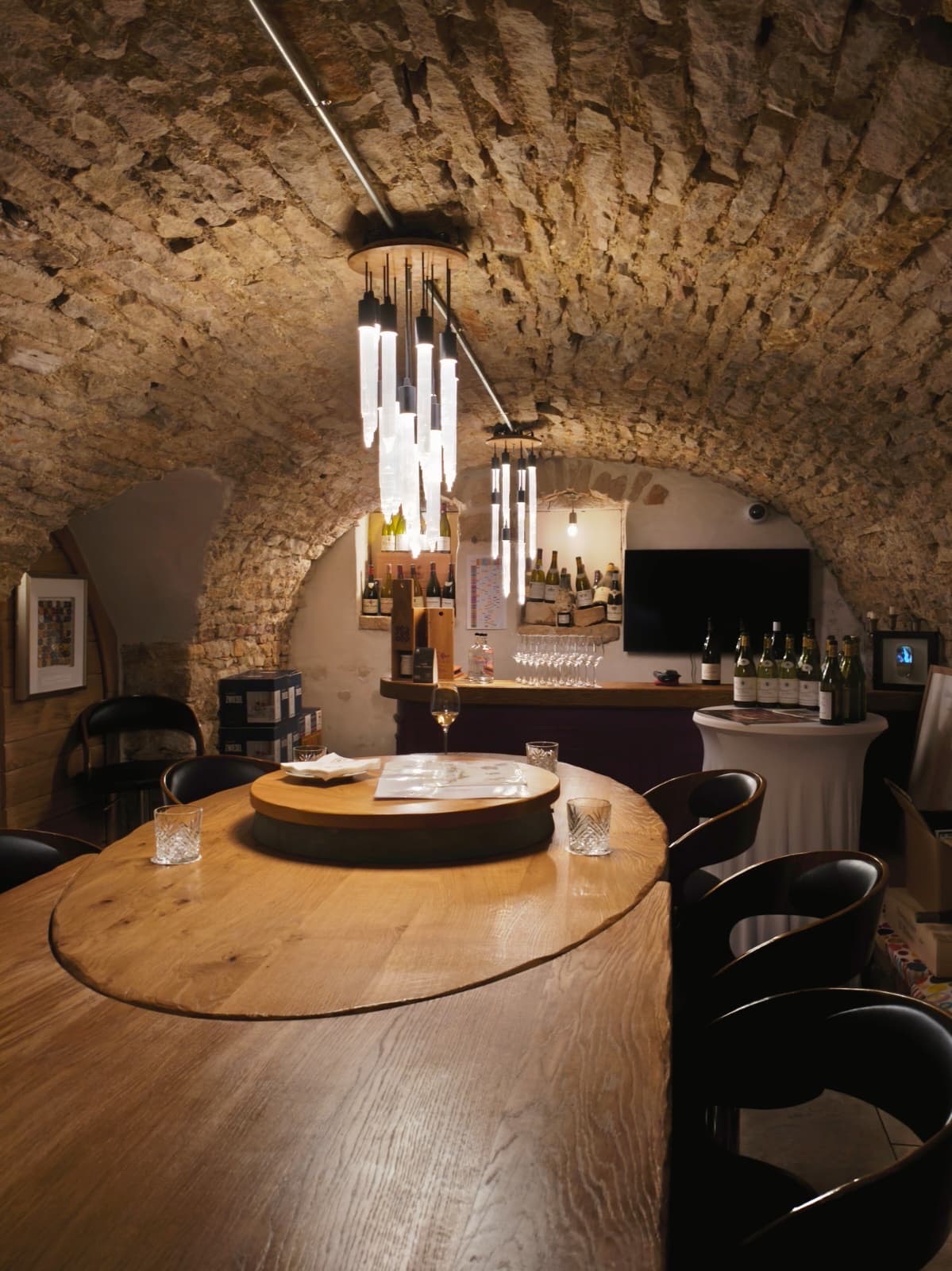 Underground tasting cellar and 24-hour wine bar at Le Cep in Beaune with a round oak table