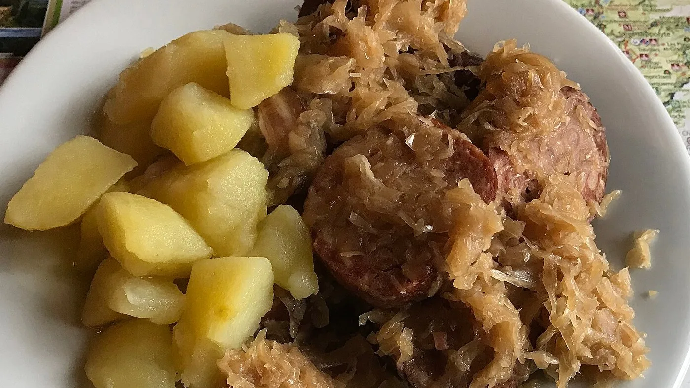 A plate of choucroute garnie with smoked sausage, pork and boiled potatoes