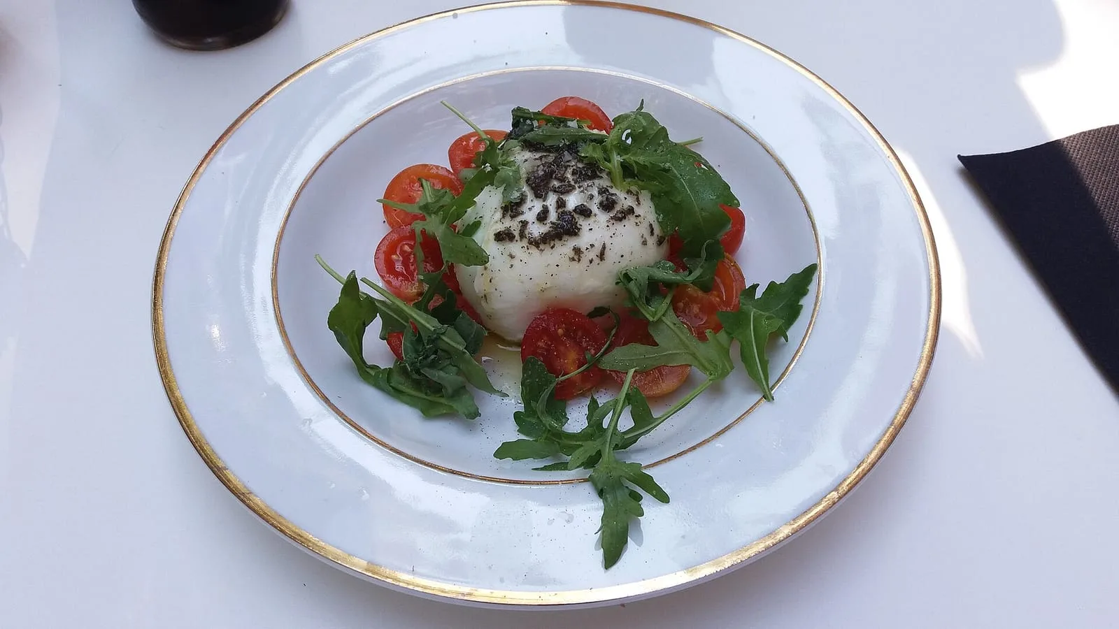 Buffalo mozzarella served with cherry tomatoes, rocket and shaved truffle