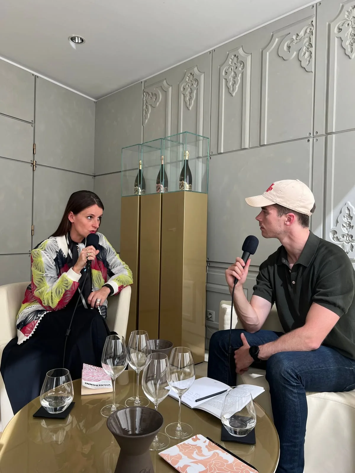Antoine interviewing Maud Rabin, managing director of Rare Champagne, in the Salon Marie-Antoinette at the house's Reims headquarters, with Rare bottles and tasting glasses on the table