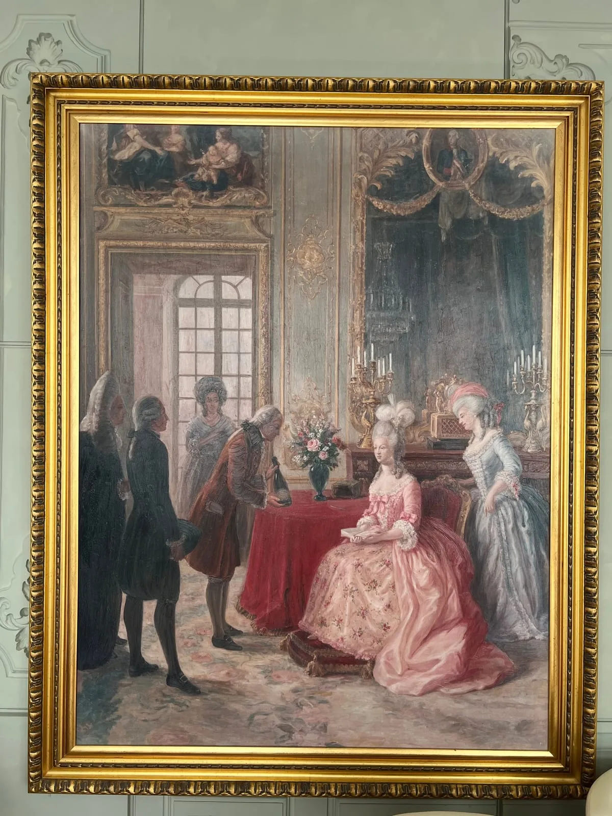 An oil painting hanging at Rare Champagne's Reims headquarters, showing Marie-Antoinette receiving a presentation in a salon at Versailles